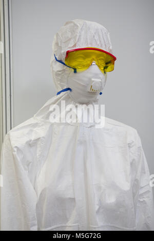Mannequin in white protective clothing, respirator and plastic glasses Stock Photo