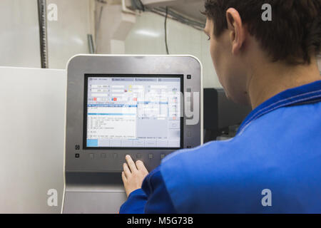 Man manage remote control for robotics arm technowelding on industry Stock Photo