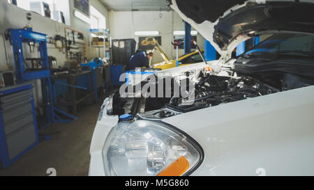 Car preparing for repairing - garage mechanical workshop, small business Stock Photo