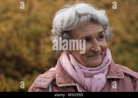 Senior woman in warm clothing outdoors Stock Photo