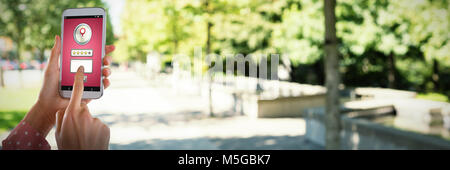 Composite image of womans hands using mobile phone Stock Photo