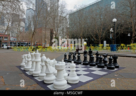 WA13664-00...WASHINGTON - Large outdoor chess set as well as tables, chairs, ping pong tables and foosball games in Occidental Park. 2017 Stock Photo