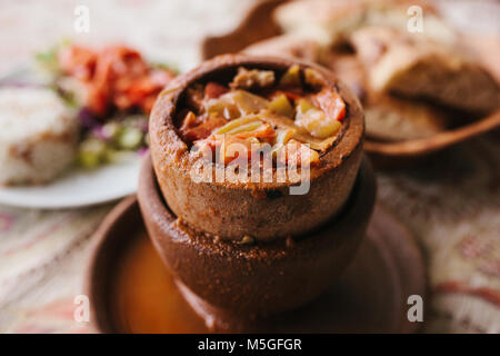 The national Turkish dish in the pot that is broken before use is called Testi-kebab. Restaurant with Turkish food. Stock Photo