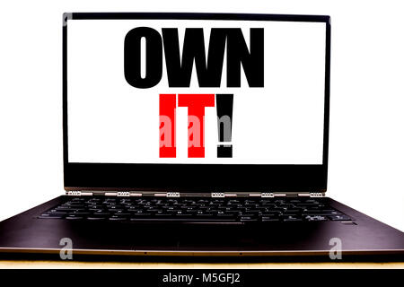 Handwritten text showing Own It Exclamation. Business concept writing for Ownership Control Written on monitor front screen, white background with spa Stock Photo