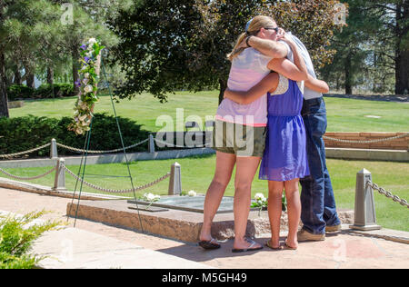 June ,  Wrea laying ceremony - Citizens Cemetery, Flagstaff  Members of the Naselroad family embrace after placing roses  on the TWA Memorial during the wreath laying ceremony at Citizens Cemetery, Flagstaff, AZ. Stock Photo