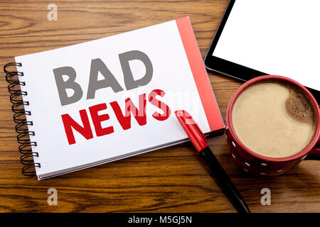 Handwriting Announcement text showing Bad News. Business concept for Failure Media Newspaper Written on notepad paper on wooden background with space  Stock Photo