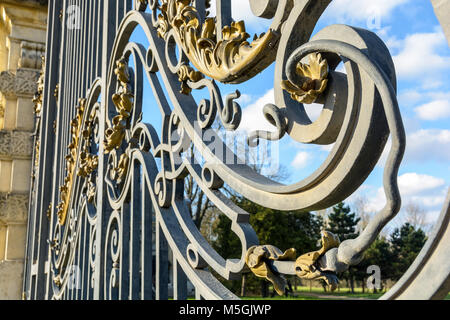Close-up view of the golden wrought iron decorations of the main entrance gate of the Noisiel public park in the eastern suburbs of Paris. Stock Photo