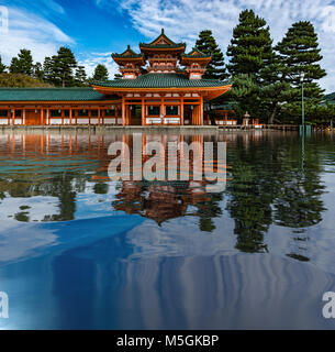 beautiful Japanese temple shrine reflecting on a lake with blue sky coloring Stock Photo