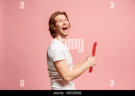 The happy businessman with red laptop on pink Stock Photo