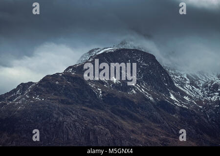 Scenic mountain peak capped in dramatic clouds at winter. Snowdonia National Park in North Wales, UK Stock Photo