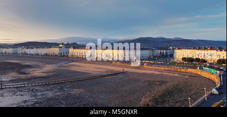 Llandudno northern shore parade in warm sunrise light at low tide. North Wales, UK Stock Photo