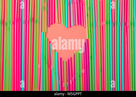 pink heart made of multicolored drinking straws. Stock Photo