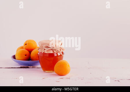 Apricot jam and apricots. Selective focus. Stock Photo