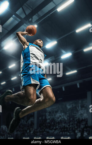 Concentrated man, basketball player in motion with ball during game ...