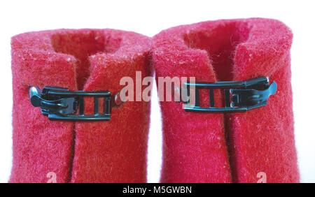 Iron clasps on the felt red boots on white background Stock Photo