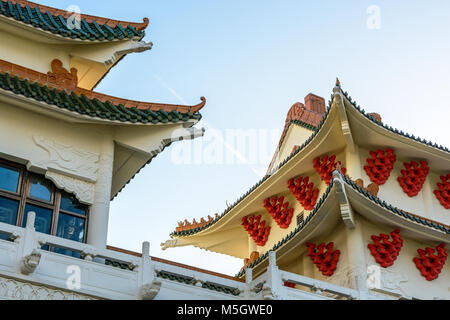 View of the chinese-inspired architecture of the Huatian Chinagora hotel complex with curved roof corners and traditional glazed roof tiles. Stock Photo