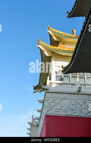 View of the chinese-inspired architecture of the Huatian Chinagora hotel complex with curved roof corners and traditional glazed roof tiles. Stock Photo