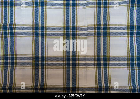 Background of a tablecloth or napkin checkered on blue, white and orange. Fabric for picnics with nothing in it. Stock Photo