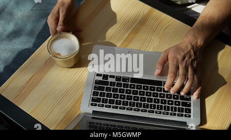 Critic uses laptop for work.  Stock Photo