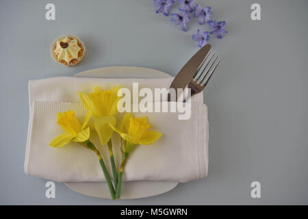 spring or summer time table place setting with flowers and cake Stock Photo