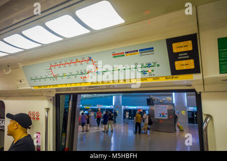 SINGAPORE, SINGAPORE - JANUARY 30, 2018: Indoor view of informative sign of train stops view from inside of Mass Rapid Transit MRT train through the c Stock Photo