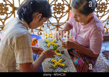 Kor Nat: U Na Auk temple, woman, flower arrangement, , Kayin (Karen) State, Myanmar (Burma) Stock Photo