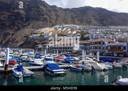 The harbour with boats and huge cliffs, Los Gigantes, Tenerife, Canary Islands, Spain Stock Photo
