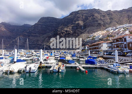 The harbour with boats and huge cliffs, Los Gigantes, Tenerife, Canary Islands, Spain Stock Photo