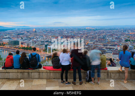 Group of people overlooking Budapest city from top viewing point on Gellert hill Stock Photo