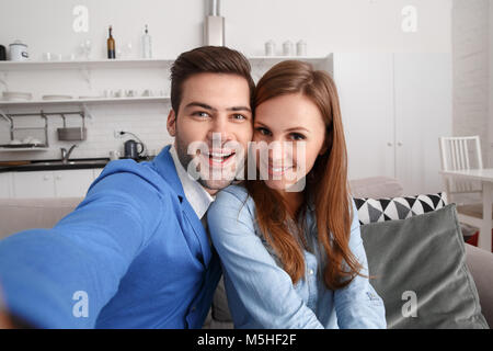 Young couple together at home weekend taking selfie photos cheerful Stock Photo