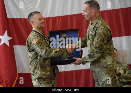 Indiana National Guard Command Sgt. Maj. James H. Martin Jr., of Reelsville, receives a gift from Maj. Gen. David C. Wood, 38th Infantry Division commanding general, Saturday, Feb. 10, 2018, in Indianapolis. Martin retired from military service after more than 33 years. He most recently served as the senior enlisted adviser and top noncommissioned officer for the division, a position he held since May 2015. “I couldn’t ask for a finer NCO than CSM Martin over the last three years,” said Wood. “He set the standard for soldiers throughout the division and always did the right thing.” Martin and  Stock Photo