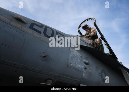 ARABIAN GULF (Feb. 12, 2018) Col. Frank Latt enters an F/A-18C Hornet, assigned to the Checkerboards of Marine Strike Fighter Attack Squadron (VMFA) 312, on the flight deck of the aircraft carrier USS Theodore Roosevelt (CVN 71). Theodore Roosevelt and its carrier strike group are deployed to the U.S. 5th Fleet area of operations in support of maritime security operations to reassure allies and partners and preserve the freedom of navigation and the free flow of commerce in the region. (U.S. Navy Stock Photo