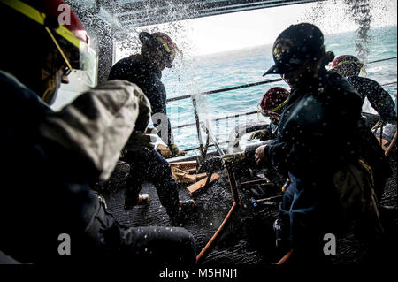 U.S. Sailors patch pipes during a damage control drill on the boat deck of the aircraft carrier USS Theodore Roosevelt (CVN 71) in the Arabian Gulf Feb. 12, 2018. The Theodore Roosevelt and its carrier strike group are deployed to the U.S. 5th Fleet area of operations in support of maritime security operations to reassure allies and partners and preserve the freedom of navigation and the free flow of commerce in the region. (U.S. Navy Stock Photo