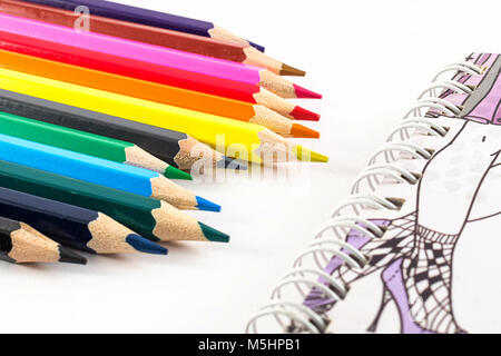 Color pencils and notebook on white background Stock Photo