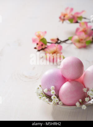 Plate  with pink   Easter eggs on wooden table. Focus on the  Easter eggs Stock Photo