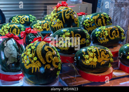 Ornately decorated watermelon celebrating the Chinese New Year are for sale on a street in Hanoi, Vietnam. Stock Photo