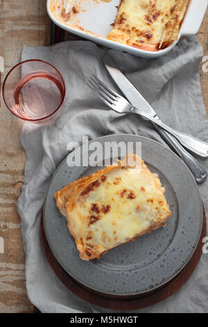 Traditional lasagna in glass baking dish on white wooden table Stock ...