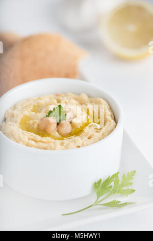 Chick-pea traditional hummus in a dish with olive oil. Stock Photo