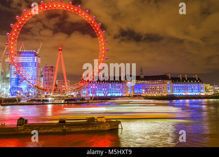 London, United Kingdom, February 17, 2018: UK skyline in the evening. Ilumination of the London Eye and the buildings next to River Thames Stock Photo