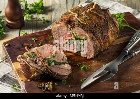 Roasted Stuffed Leg of Lamb with Spinach and Pine Nuts Stock Photo