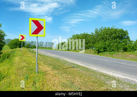 Dangerous turns, triangle warning traffic sign near rural road Stock Photo  - Alamy