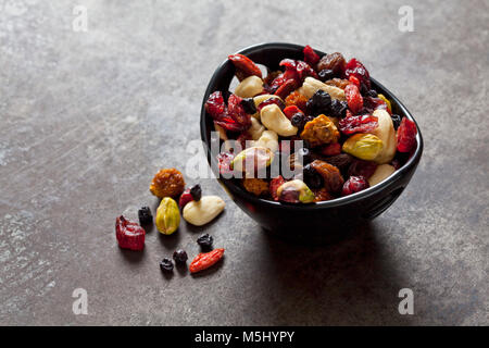 Bowl of dried fruits, pistachios, cashew nuts and almonds Stock Photo