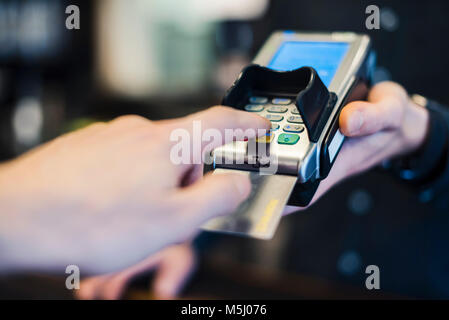 Man using credit card reader, close-up Stock Photo