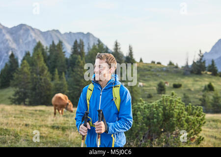 Austria, Tyrol, Mieming Plateau, portrait of smiling hiker on alpine meadow Stock Photo
