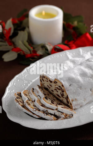 Stollen and Christmas wreath on a table Stock Photo