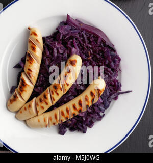 Grilled sausages with braised red cabbage Stock Photo