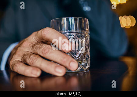 Close-up of man in a bar with tumbler Stock Photo