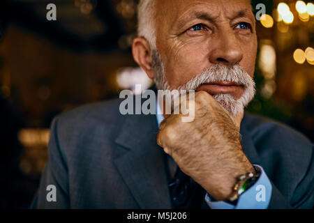 Portrait of elegant senior man thinking Stock Photo