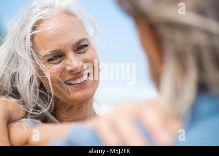 Handsome senior couple dancing on the beach Stock Photo