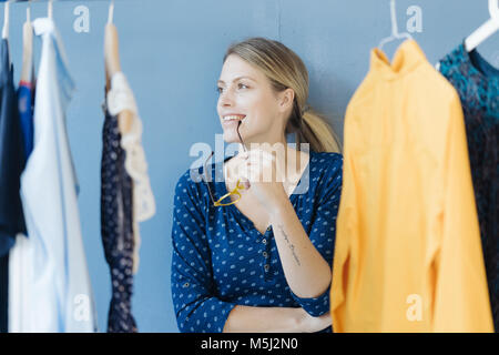 Portrait of happy fashion designer in her studio Stock Photo